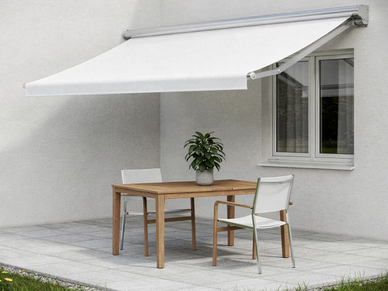 Extended cassette awning over a terrace with a garden table and chairs